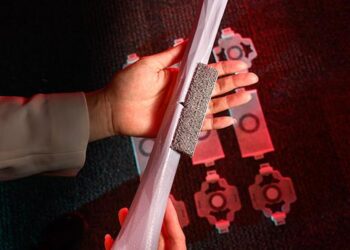 The team shows their 3D-printed resin prototype of the new bio-inspired material, here attached to a synthetic model of a fractured human femur.