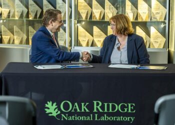 Hood Whitson, chief executive officer of Element3, and Cynthia Jenks, associate laboratory director for the Physical Sciences Directorate, shake hands