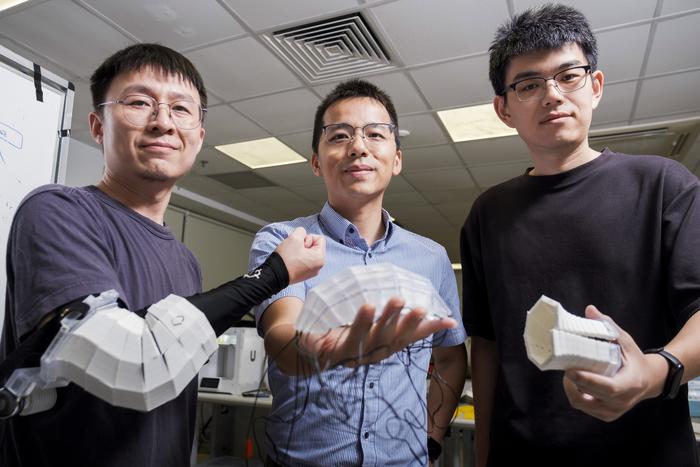 NTU PhD student Mr Yang Xudong, Assistant Professor Wang Yifan and PhD student Mr Chen Tianyu, holding various prototypes made using the RoboFabric