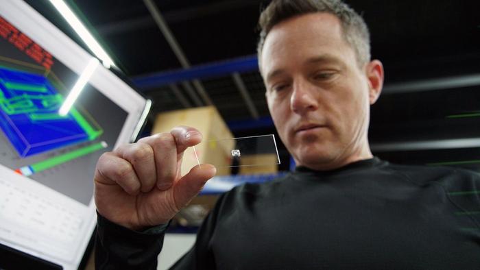 Jeff Schultz'03 inspects a 3D-printed organ on a chip at his lab in Charlotte.