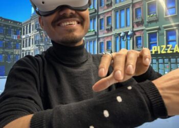 Seamless navigation in a virtual reality environment using a knitted sleeve with overbraided magnetic field sensors and a magnetic ring.