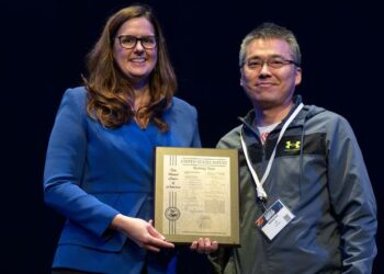 Baohong Yuan receiving acknowledgement of his patent from President Jennifer Cowley