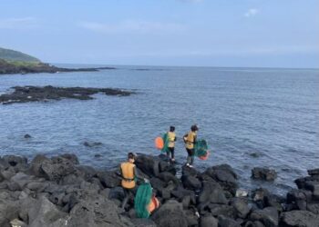 Group of Haenyeo divers on a rocky shore