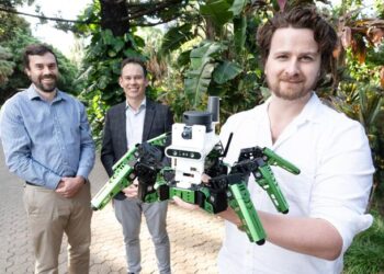 Dr Adam Hines and his green robot