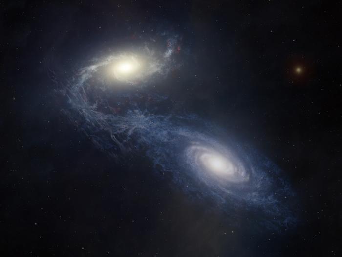 Giant spiral galaxy NGC 1365 merging with another galaxy