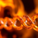 Glass Defies Disorder as Heat Flows Near the Quantum Limit in Atomic Chains