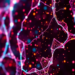 Near-infrared holography breaks the visible-light scattering barrier in lensless microscopy