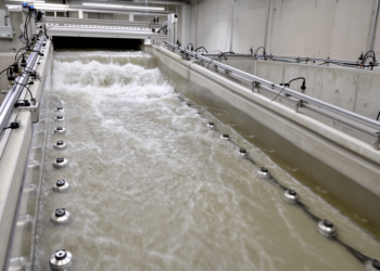 Flume study quantifies dam-break pressure on sloping wet beds