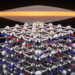Non-Collinear Magnetism Creates Flat Electronic Bands in Predicted Topological Material CoBi2Te4